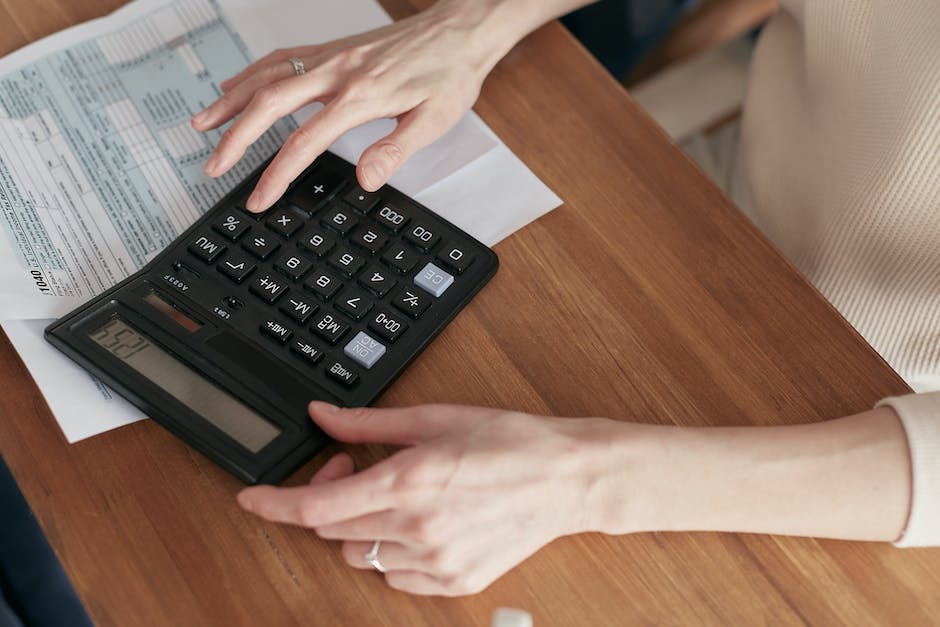 Image describing strategies for paying off personal loans for home improvements, showing a person with a calculator and money in the background